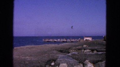 1963: rocky area of beach with waves crashing