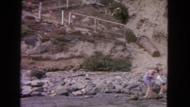 1963: people walking up stairs by rocky cliff CALIFORNIA