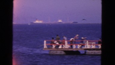 1963: large cargo ship is moving through the blue waters of the sea CALIFORNIA