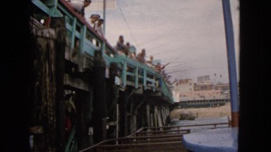 1963: large group of men fishing together at the pier