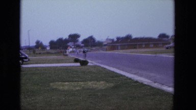 1975: Person and Baby Riding Bicycle on Open Road California