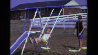 1975: mother and child swing CALIFORNIA