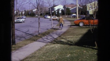 1975: person riding bicycle down street CALIFORNIA