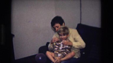 1975: mom is dressing her son CALIFORNIA