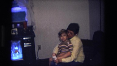1975: Mother Puts Socks on Small Child Who Waves Then Hides Near Television Set
