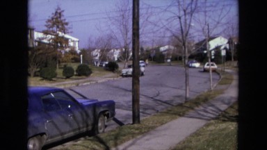 1975: person riding bike up neighborhood street CALIFORNIA