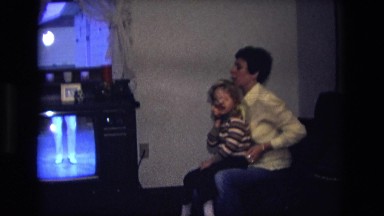 1975: parent and child watching dance show on television. CALIFORNIA
