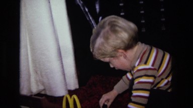 1975: blonde haired boy is playing with toys on the floor of the room CALIFORNIA