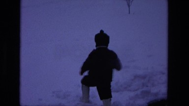 1975: two toddlers play in the snow on their front yard CALIFORNIA