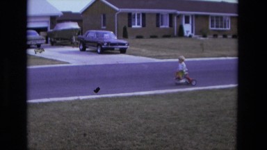 1975: boy riding his bike backwards on the street CALIFORNIA