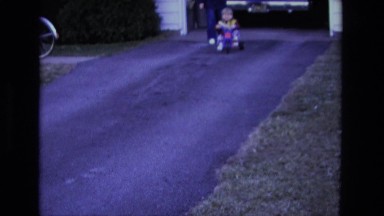 1975: kid going down driveway in hot wheels seated style car racer CALIFORNIA