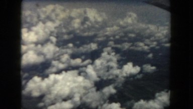 1962: view from airplane window looking out at clouds below SAN PEDRO