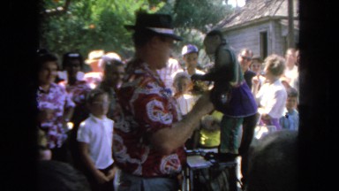 1962: in crowded monkey show, showman collects something