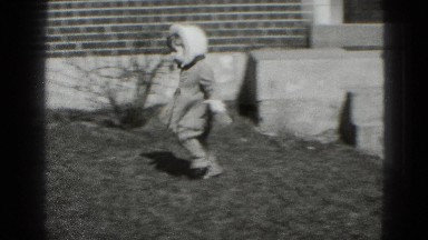 1947: Small Girl Runs Across Yard in Coat and Bonnet Toward Another Person Middletown