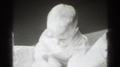 1947: adorable baby plays with newspaper. MIDDLETOWN