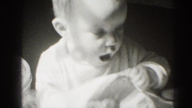 1947: sweet little baby playing with piece of paper MIDDLETOWN