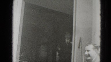 1947: older newly weds exiting church and being pummeled by flying rice