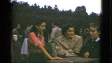 1953: three women at an event talking and smiling. CALIFORNIA