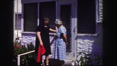 1960: Two Older Women Leave House and Sit on Lawn Chairs in Florida Yard
