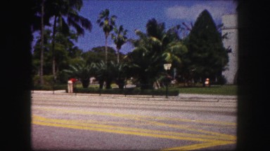 1960: People Crossing Street in Front of Big Building Florida