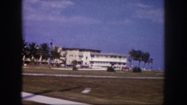 1960: coastal hotel or resort as seen from moving vehicle FLORIDA