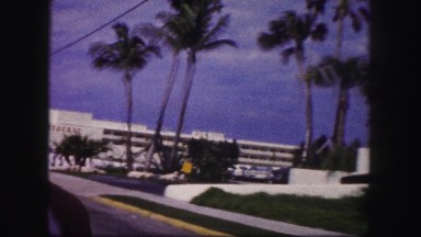 1960: Driving Past Aristocrat and Henri Hotels in Car on Paved Streets Florida