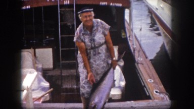1960: old woman happily shows off the catch of the day FLORIDA