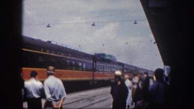 1960: the train station is bustling with people as train approaches