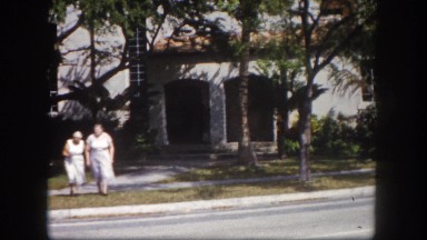 1960: older woman being helped across the street by younger woman FLORIDA