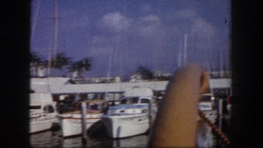 1960: medium sized motorized boats, and few sailboats are at marina FLORIDA