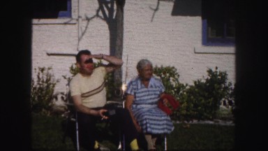 1960: son looking at something as he sits with his mother FLORIDA