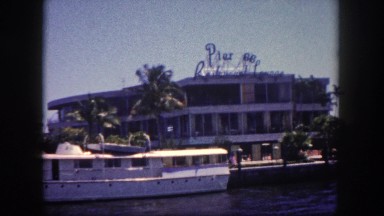 1960: cruising harbor waters boating alongside commercial buildings FLORIDA