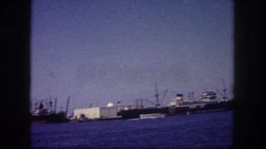 1960: industrial tanker ships docks outside harbor waiting for port entry