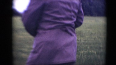 1947: middle aged caucasian white chubby man walking in open field in gray suit