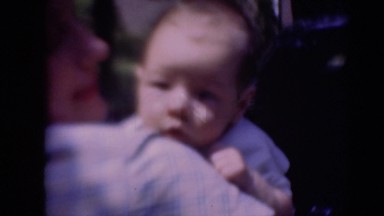 1947: father holding baby as it looks on the camera MIDDLETOWN