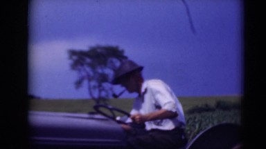 1947: man driving tractor outdoors looking at something on his right MIDDLETOWN