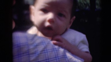 1947: the innocent look of kid over it's mothers shoulder MIDDLETOWN