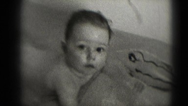 1947: cute baby boy floating in tub with inflatable fish bath toy MIDDLETOWN
