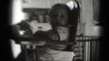 1947: baby in high chair staring off into space MIDDLETOWN