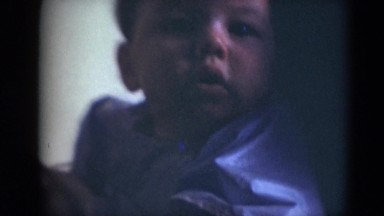 1947: chubby cheeks cute baby boy in bib ready for eating time MIDDLETOWN