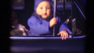 1947: baby sitting in the window of car playing with stuffed dog MIDDLETOWN