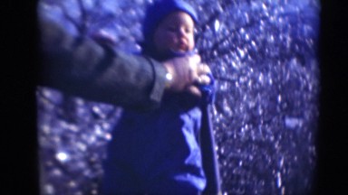 1947: man attempting to help steady toddler while standing MIDDLETOWN