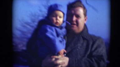 1947: fat father holding chubby child and tries to make him smile MIDDLETOWN