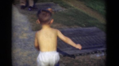 1947: boy playing and helping his father to find and set the golf ball