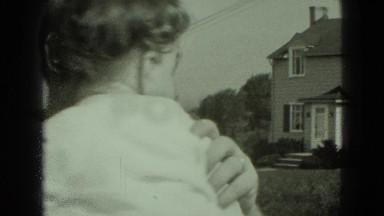 1947: man holds baby and kisses it on the cheek MIDDLETOWN