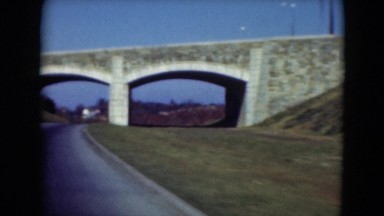 1947: driving under stone arched bridge with lampposts on top of it MIDDLETOWN