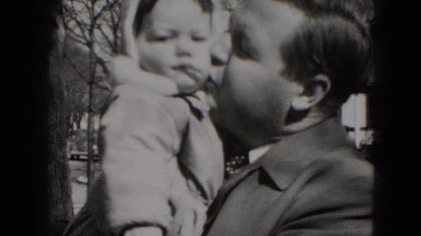 1949: man proudly holding and kissing toddler in his arms MIDDLETOWN