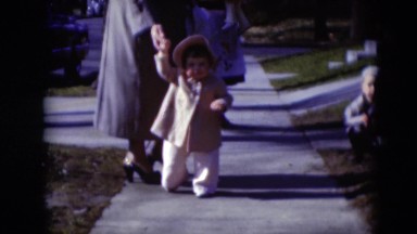 1949: toddler walking down the sidewalk with female adult. MIDDLETOWN
