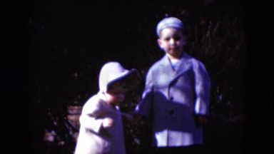 1949: boy playing with sister in school uniforms bonnets for girls MIDDLETOWN