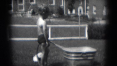1949: boy filling metal tub with water MIDDLETOWN